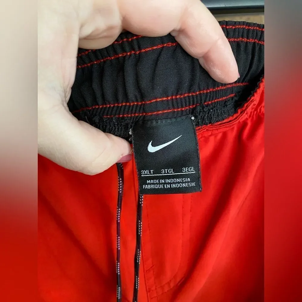 Red and black Nike swim trunks‎